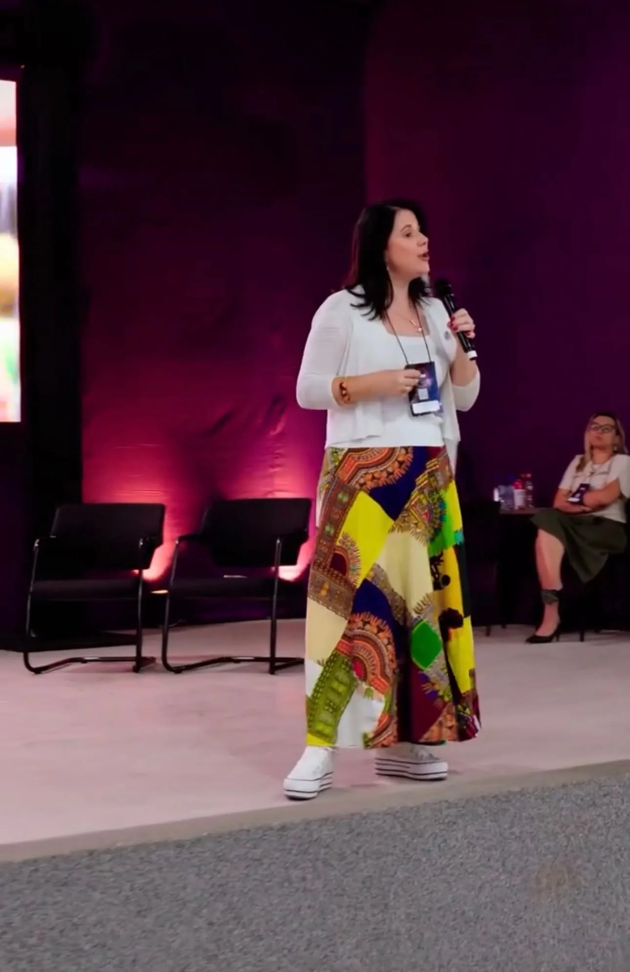 Luísa Marteleto speaking on stage